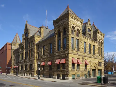 A sandstone building on a downtown Fort Wayne street corner on a clear day