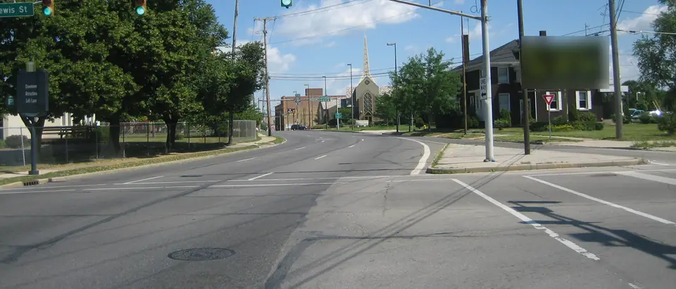 A wide Fort Wayne intersection with turn lanes and traffic lights on a sunny day