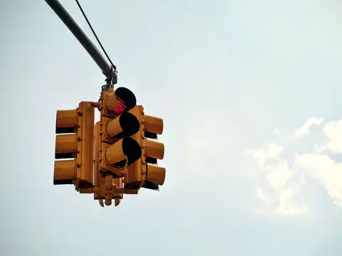 A traffic signal hanging over an intersection
