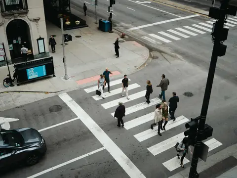 People crossing at a marked crosswalk downtown
